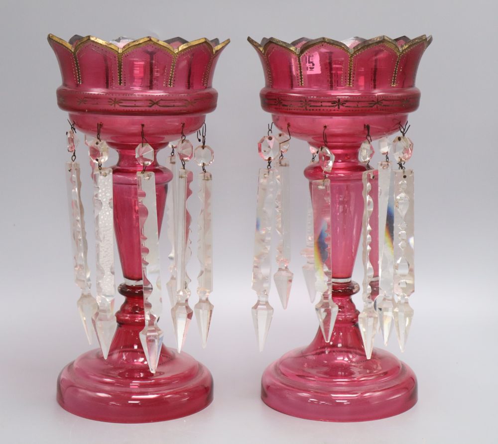 A pair of cranberry glass lustres, late 19th century, height 34cm